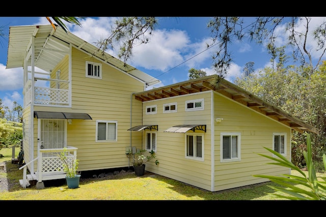 11-3250 Lehua St, Mountain View, HI 96771 - rear view of property featuring a balcony and a yard
