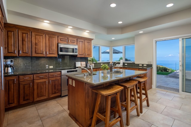 76-853 N Pakalakala Pl, Kailua-Kona, HI 96740 - kitchen with stainless steel microwave, stove, recessed lighting, tasteful backsplash, and dark stone countertops