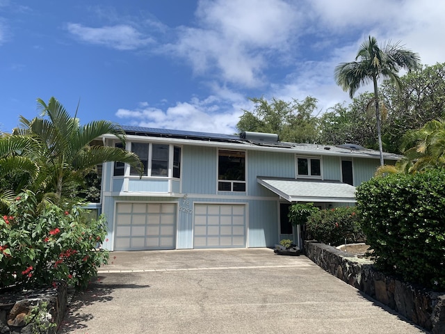 76-6252 Kokoolua Way, Kailua-Kona, HI 96740 - view of front of home featuring a garage, driveway, and roof mounted solar panels