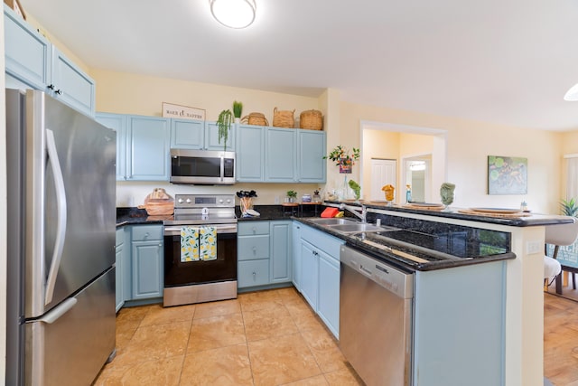 73-1102 Nuuanu Pl Unit F203, Kailua-Kona, HI 96740 - kitchen with appliances with stainless steel finishes, a peninsula, and blue cabinetry