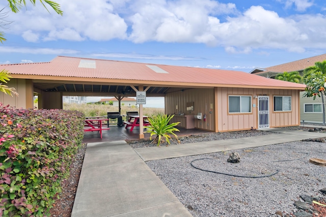 73-1102 Nuuanu Pl Unit F203, Kailua-Kona, HI 96740 - exterior space with board and batten siding, a metal roof, and a patio area