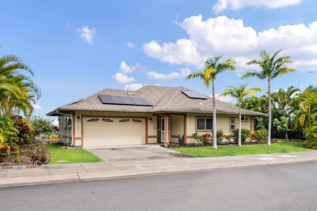 75-650 Mea Lanakila St, Kailua-Kona, HI 96740 - ranch-style home with an attached garage, driveway, roof mounted solar panels, roof with shingles, and board and batten siding