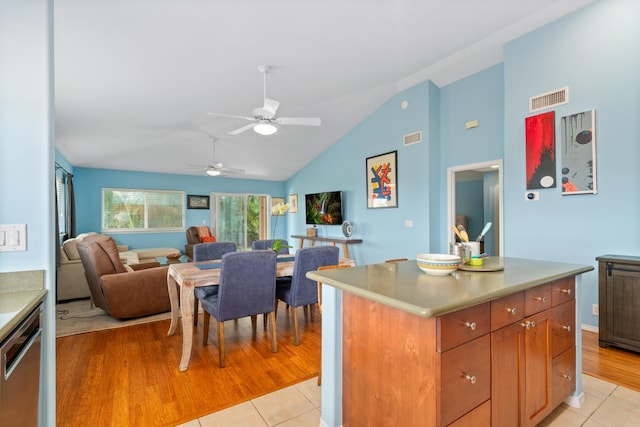 75-650 Mea Lanakila St, Kailua-Kona, HI 96740 - kitchen with a ceiling fan, stainless steel dishwasher, light tile patterned flooring, open floor plan, and high vaulted ceiling