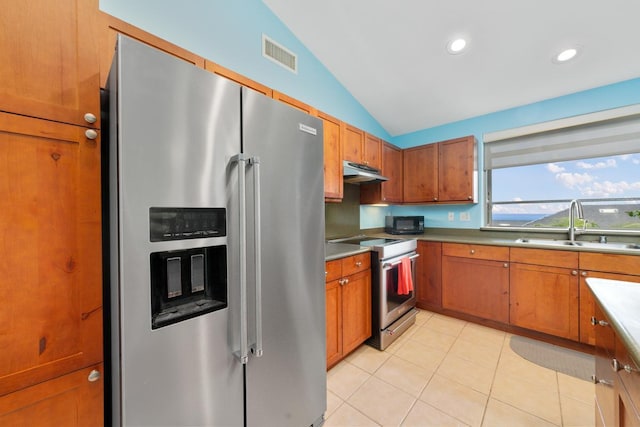 75-650 Mea Lanakila St, Kailua-Kona, HI 96740 - kitchen featuring stainless steel appliances, vaulted ceiling, under cabinet range hood, brown cabinetry, and light tile patterned floors