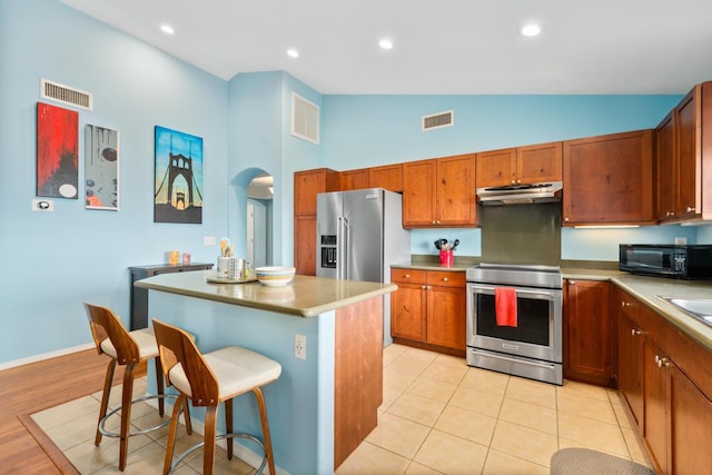 75-650 Mea Lanakila St, Kailua-Kona, HI 96740 - kitchen with stainless steel appliances, under cabinet range hood, a kitchen island, high vaulted ceiling, and a kitchen breakfast bar