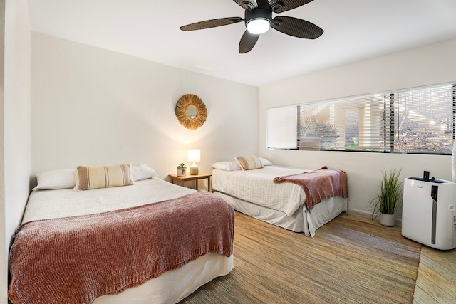 78-7070 Alii Dr Unit E103, Kailua-Kona, HI 96740 - bedroom featuring wood finished floors, ceiling fan, and baseboards