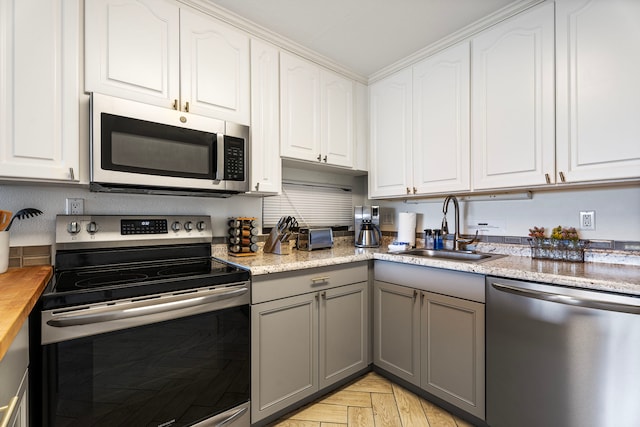 78-7070 Alii Dr Unit E103, Kailua-Kona, HI 96740 - kitchen featuring stainless steel appliances, a sink, gray cabinetry, and white cabinetry