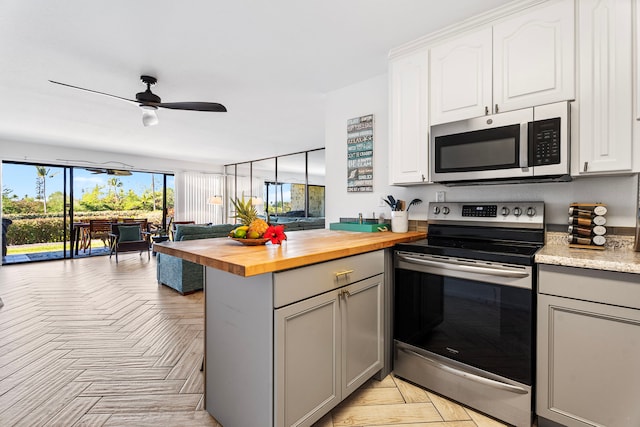 78-7070 Alii Dr Unit E103, Kailua-Kona, HI 96740 - kitchen featuring stainless steel appliances, butcher block countertops, gray cabinetry, a peninsula, and ceiling fan