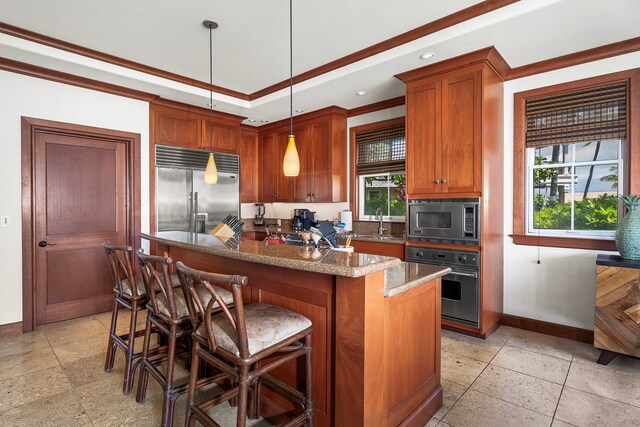 69-1000 Kolea Kai Cir Unit 4A, Waikoloa, HI 96738 - kitchen with built in appliances, a kitchen island, brown cabinetry, a breakfast bar area, and decorative light fixtures