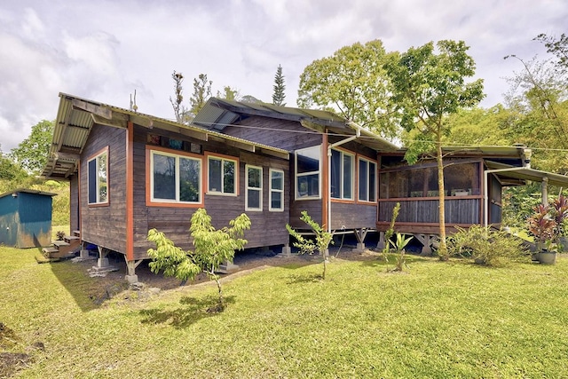 13-1312 Malama St, Pahoa, HI 96778 - rear view of house with a sunroom and a lawn