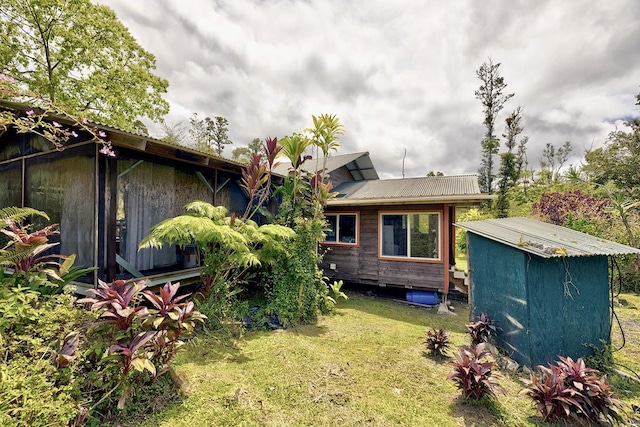 13-1312 Malama St, Pahoa, HI 96778 - back of house featuring a yard, a storage shed, and a metal roof