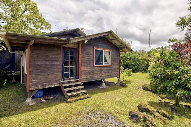 13-1312 Malama St, Pahoa, HI 96778 - view of side of home with entry steps and a yard