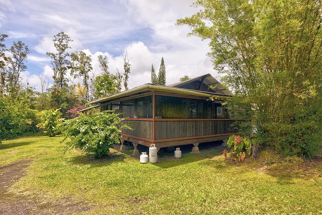 13-1312 Malama St, Pahoa, HI 96778 - rear view of property with a yard, a sunroom, and a wooden deck