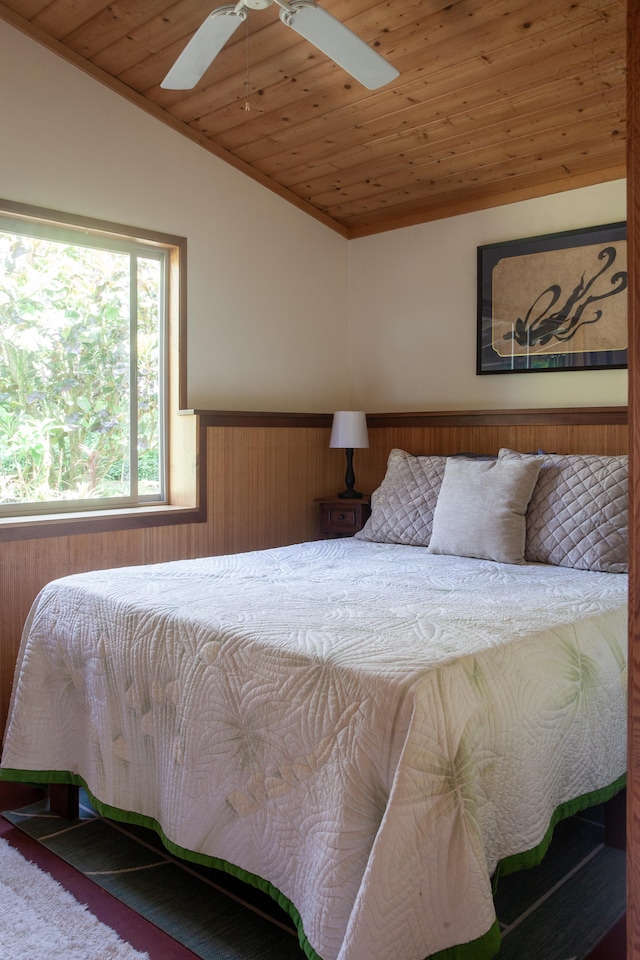 15-2045 8th Ave, Keaau, HI 96749 - carpeted bedroom featuring wooden ceiling, wainscoting, vaulted ceiling, ceiling fan, and wooden walls
