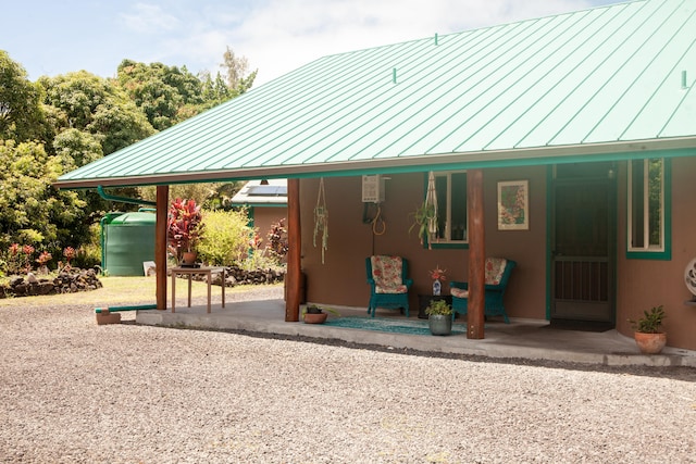 15-2045 8th Ave, Keaau, HI 96749 - rear view of house featuring a standing seam roof and a metal roof