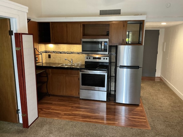 400 Hualani St Unit 1301, Hilo, HI 96720 - kitchen with appliances with stainless steel finishes, open shelves, dark countertops, dark colored carpet, and decorative backsplash