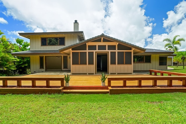 4675 Wailapa Rd, Kilauea, HI 96754 - back of property with a chimney, board and batten siding, a yard, and a wooden deck