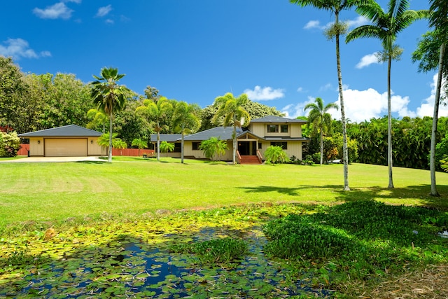 4675 Wailapa Rd, Kilauea, HI 96754 - view of grassy yard featuring a garage