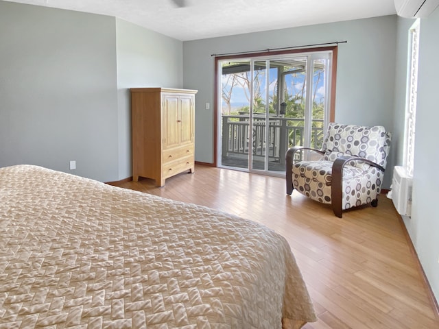 76-6323 Mahuahua Pl, Kailua-Kona, HI 96740 - bedroom featuring access to outside, wood finished floors, and a wall unit AC