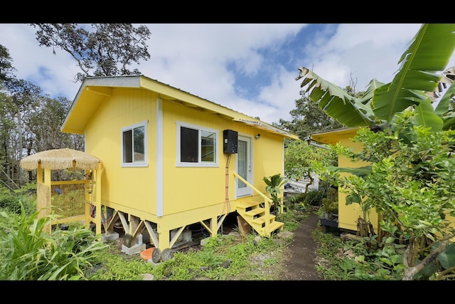 11-2722 Makoa Rd, Volcano, HI 96785 - rear view of house featuring entry steps and a metal roof
