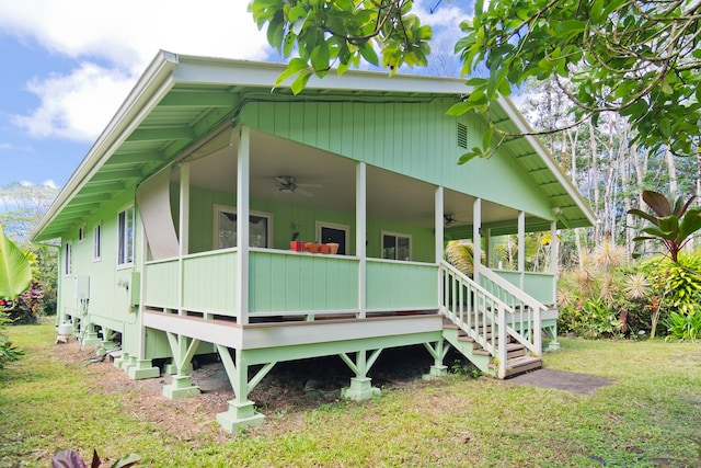 14-3385 Paradise Rd, Pahoa, HI 96778 - view of front of property with a ceiling fan, a front yard, and a deck