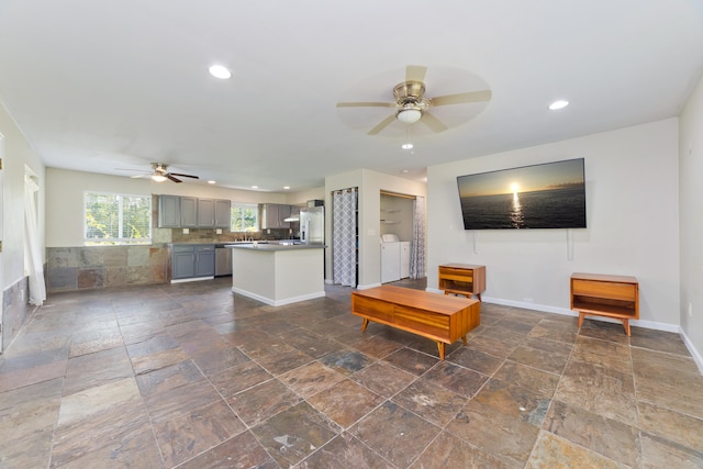 14-3385 Paradise Rd, Pahoa, HI 96778 - living area with ceiling fan, washer and dryer, stone tile floors, and recessed lighting
