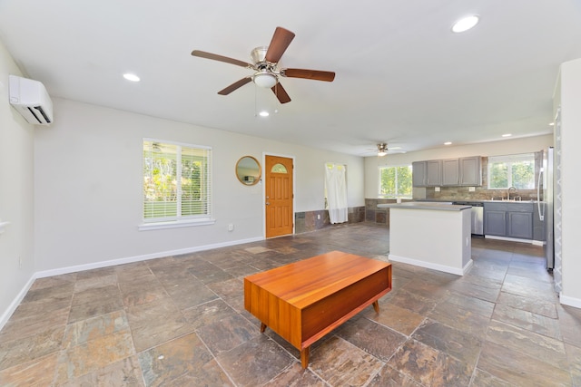 14-3385 Paradise Rd, Pahoa, HI 96778 - unfurnished living room with a wall mounted AC, recessed lighting, a ceiling fan, and stone tile flooring