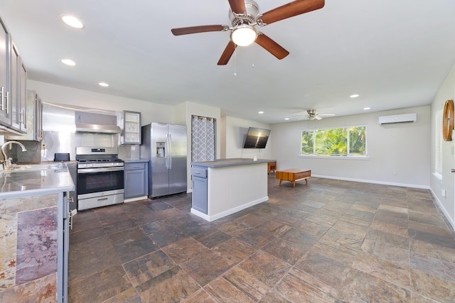 14-3385 Paradise Rd, Pahoa, HI 96778 - kitchen featuring appliances with stainless steel finishes, a ceiling fan, stone tile floors, wall chimney exhaust hood, and recessed lighting