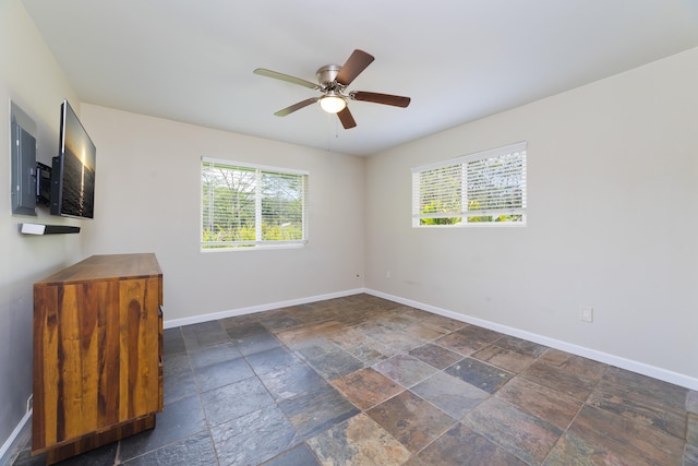 14-3385 Paradise Rd, Pahoa, HI 96778 - unfurnished room featuring plenty of natural light, stone tile flooring, and a ceiling fan