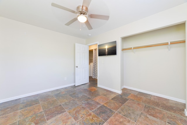 14-3385 Paradise Rd, Pahoa, HI 96778 - unfurnished bedroom with stone tile floors, a closet, and ceiling fan