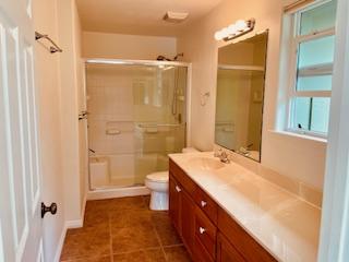 94-1654 Lewa Nuu St, Naalehu, HI 96772 - full bathroom with vanity, a stall shower, and tile patterned floors