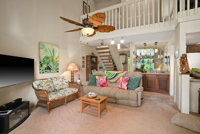 3880 Wyllie Rd Unit 21C, Princeville, HI 96722 - living room with a towering ceiling, light carpet, stairs, ceiling fan, and track lighting