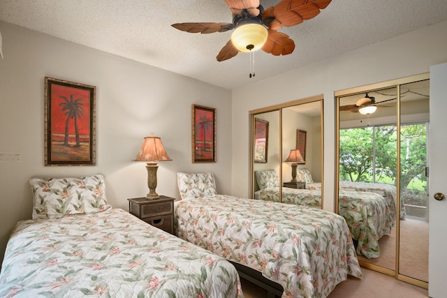 3880 Wyllie Rd Unit 21C, Princeville, HI 96722 - carpeted bedroom with multiple closets, access to exterior, a ceiling fan, and a textured ceiling
