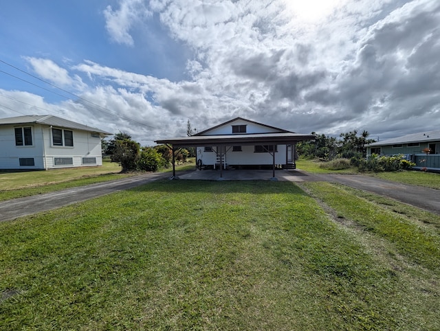 90 Santos St, Hilo, HI 96720 - view of front of house with driveway, an attached carport, and a front yard
