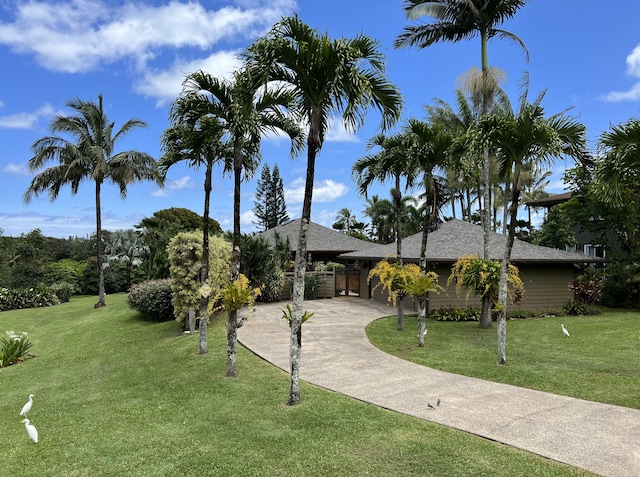 4892 Pepelani Lp, Princeville, HI 96722 - view of front of house with a front yard and a shingled roof