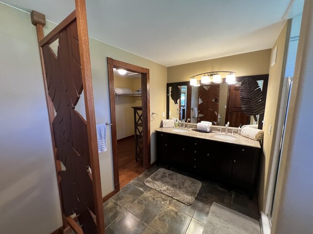 4892 Pepelani Lp, Princeville, HI 96722 - bathroom with double vanity and a walk in closet