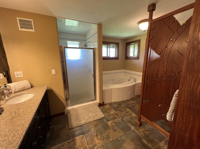 4892 Pepelani Lp, Princeville, HI 96722 - full bath featuring vanity, a garden tub, a shower stall, baseboards, and stone finish flooring