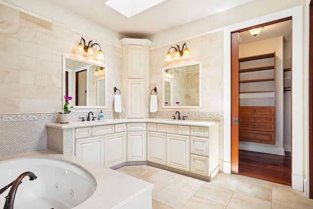 2758 Milo Hae Lp, Koloa, HI 96756 - bathroom featuring a skylight, double vanity, tile patterned flooring, a jetted tub, and tile walls