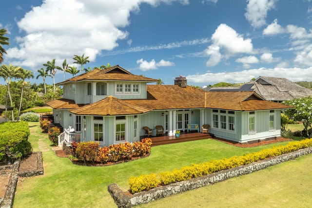 2758 Milo Hae Lp, Koloa, HI 96756 - back of house featuring board and batten siding, a chimney, and a yard