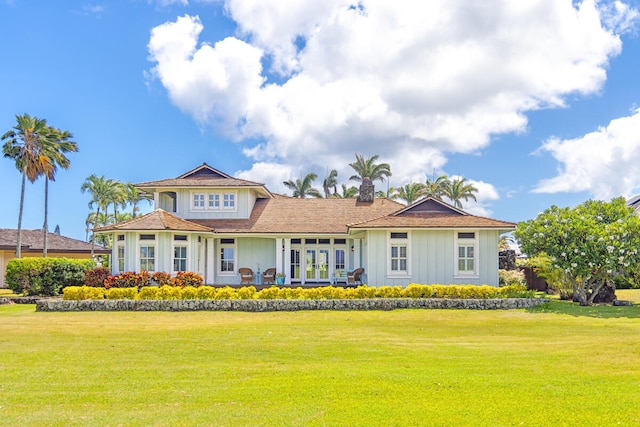 2758 Milo Hae Lp, Koloa, HI 96756 - view of front of house with a chimney, a front lawn, board and batten siding, and french doors