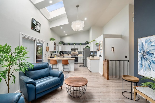 68-1846 Puu Nui St, Waikoloa, HI 96738 - living area with light wood finished floors, a chandelier, high vaulted ceiling, a skylight, and recessed lighting