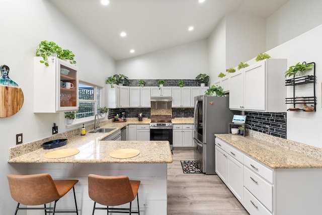 68-1846 Puu Nui St, Waikoloa, HI 96738 - kitchen featuring high vaulted ceiling, stainless steel appliances, a peninsula, recessed lighting, and backsplash