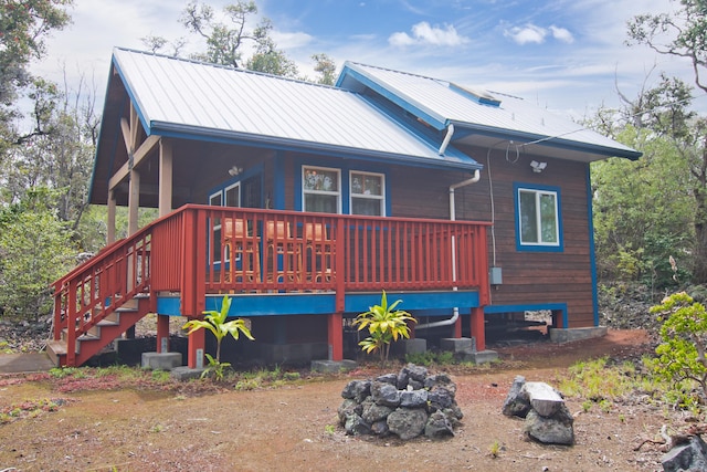 92-8618 Orchid Pkwy, Ocean View, HI 96737 - back of house featuring a metal roof, a fire pit, and stairs