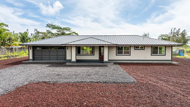 15-1571 19th Ave, Keaau, HI 96749 - ranch-style house featuring a metal roof, gravel driveway, covered porch, and an attached garage