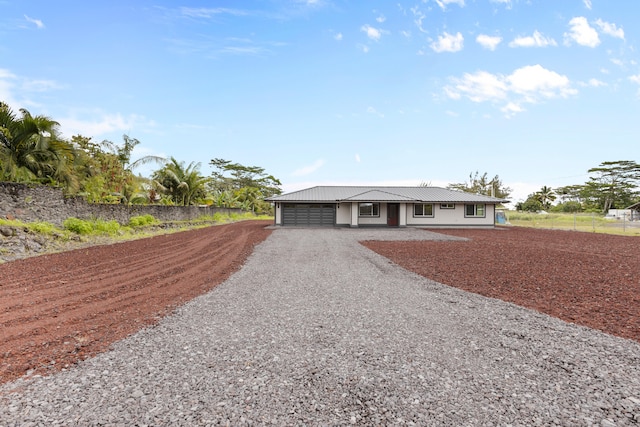 15-1571 19th Ave, Keaau, HI 96749 - ranch-style home featuring gravel driveway, a garage, and a metal roof