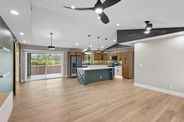 15-1571 19th Ave, Keaau, HI 96749 - kitchen with appliances with stainless steel finishes, ceiling fan, vaulted ceiling, a barn door, and light countertops