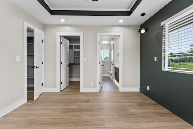 15-1571 19th Ave, Keaau, HI 96749 - unfurnished bedroom with a spacious closet, recessed lighting, light wood-type flooring, connected bathroom, and a raised ceiling