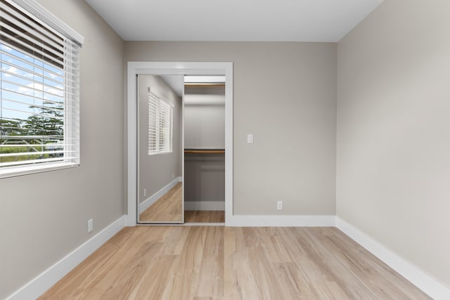 15-1571 19th Ave, Keaau, HI 96749 - unfurnished bedroom featuring wood finished floors, a spacious closet, and a closet