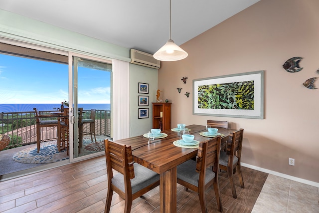 75-346 Hualalai Rd Unit B303, Kailua-Kona, HI 96740 - dining room featuring an AC wall unit, lofted ceiling, wood finished floors, and a water view