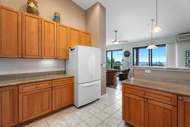 75-346 Hualalai Rd Unit B303, Kailua-Kona, HI 96740 - kitchen with freestanding refrigerator, a ceiling fan, brown cabinetry, decorative backsplash, and pendant lighting